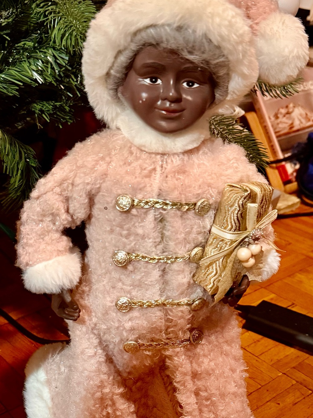 African American Mrs Claus in a Pink and White Plush robe with Gold Accents